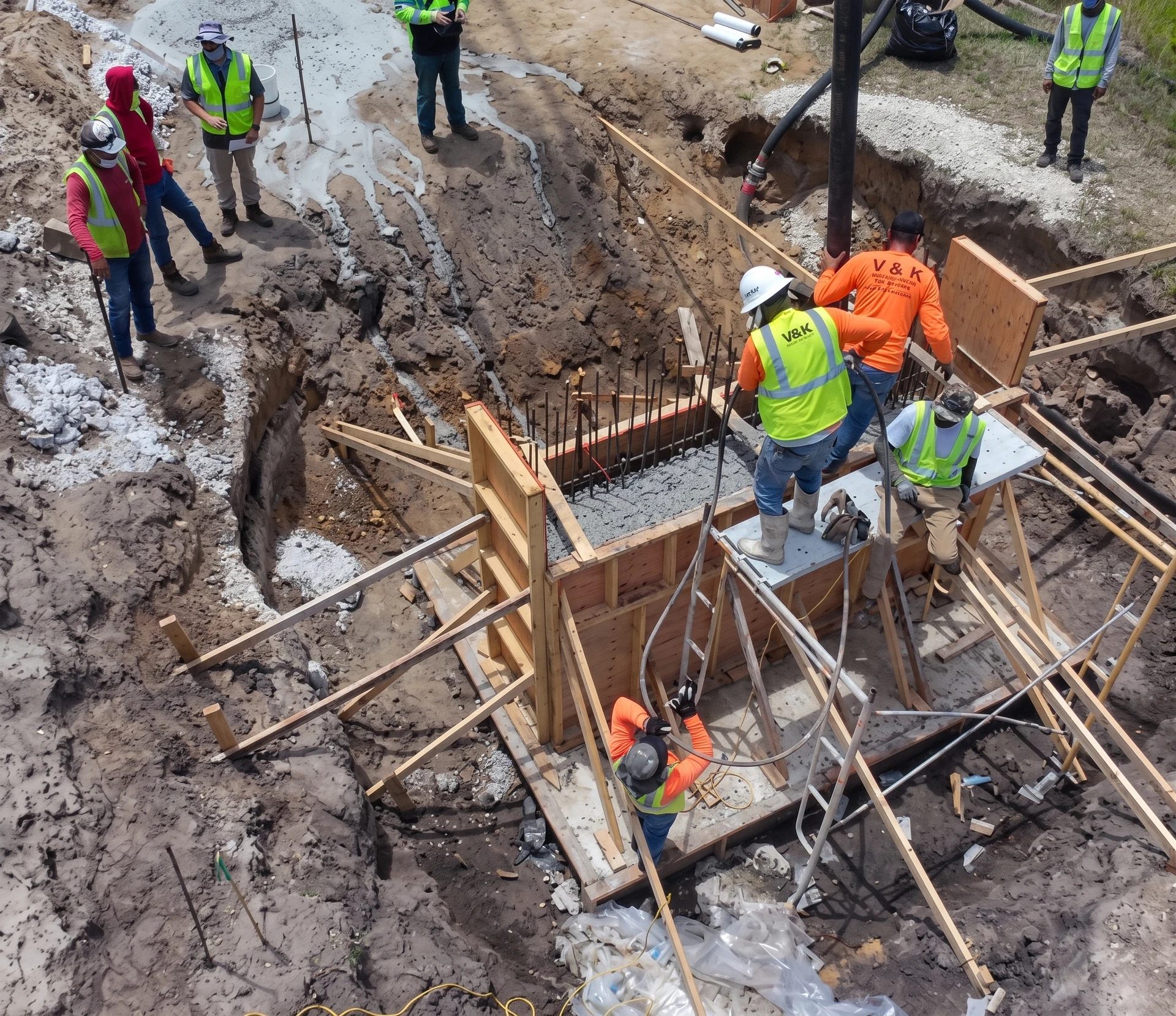 Crew working around concrete formwork and reinforcement